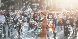 a woman blowing a cloud of bubbles