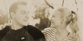 a sepia toned photograph of a young couple in love